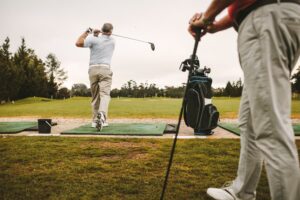 Golfers at driving range practicing their swings 