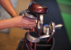 Player pulling club out of bag in pro shop 
